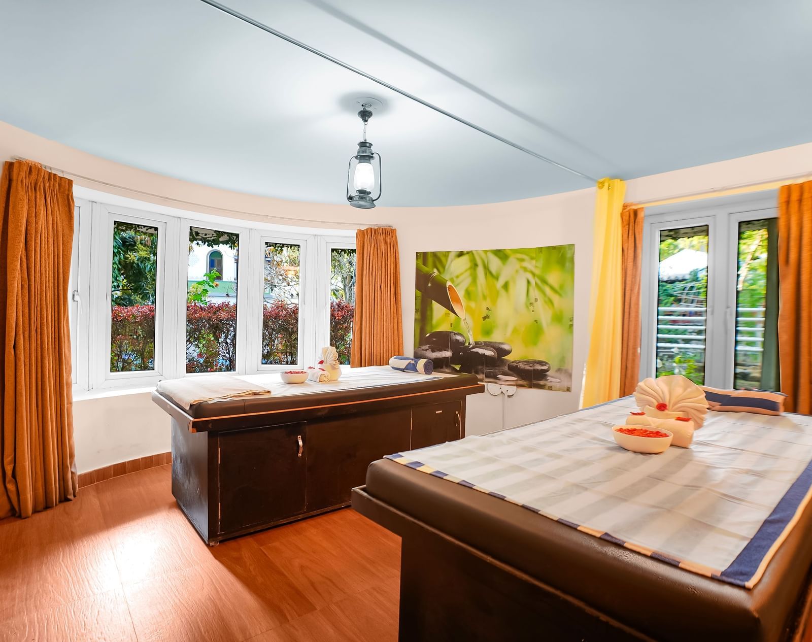 Full view of the spa room with massage tables and window curtains pulled to the side at WOW Bungalow, Yercaud.