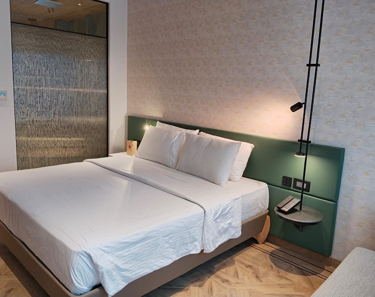 A king size bed in the Deluxe Room at Regency Hotel, Mumbai.