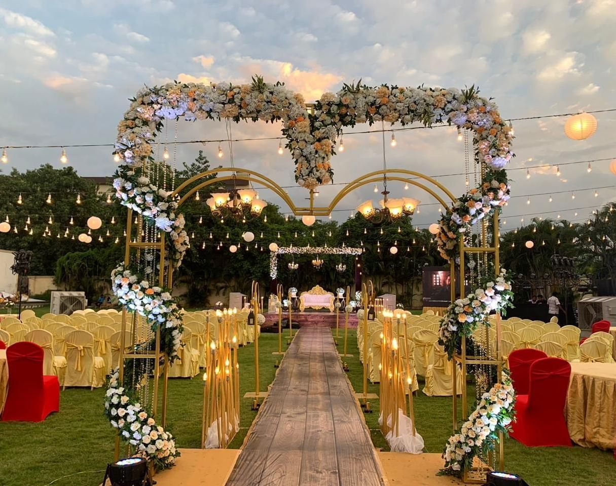 Elegant wedding entrance with heart-shaped floral arch and glowing lights at Ilara Hotels & Spa, OMR, Chennai