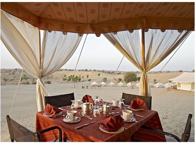 A close up shot of the outdoor dining arrangement over the arid desert region - MANVAR Resort & Desert Camp