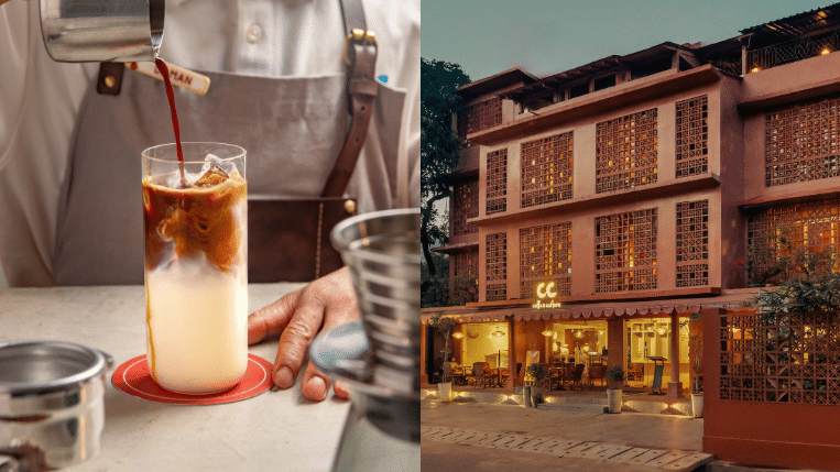 Barista pouring coffee into a glass of milk alongside an illuminated boutique hotel exterior at dusk.
