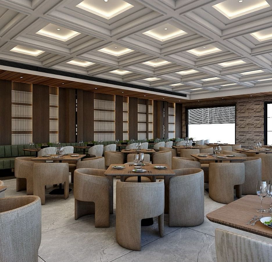 Corner view image of the restaurant with well arranged seating area and a false ceiling above it - Namaste Corbett