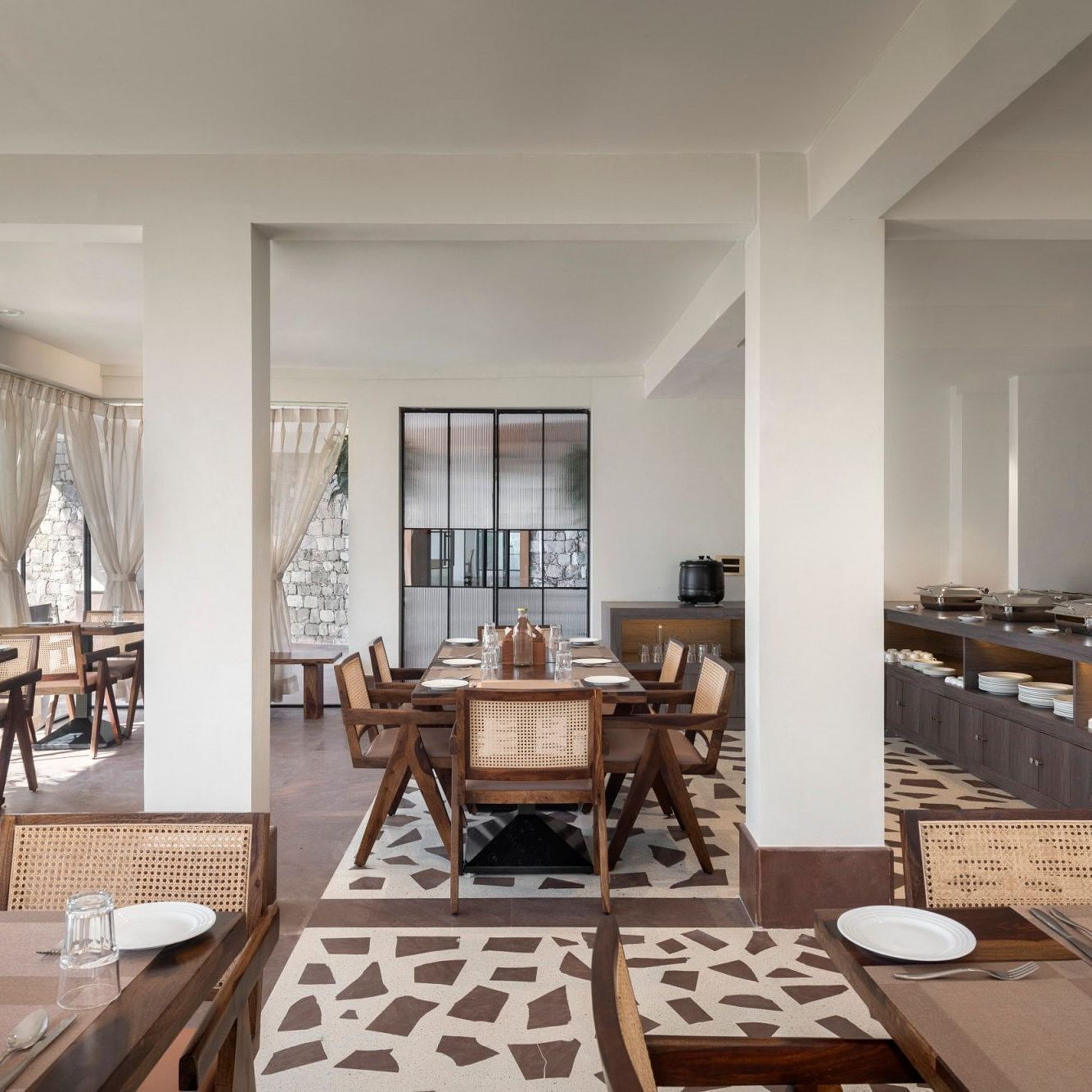 An interior view of a restaurant with wooden chairs and tables - The Samai, Bhimtal