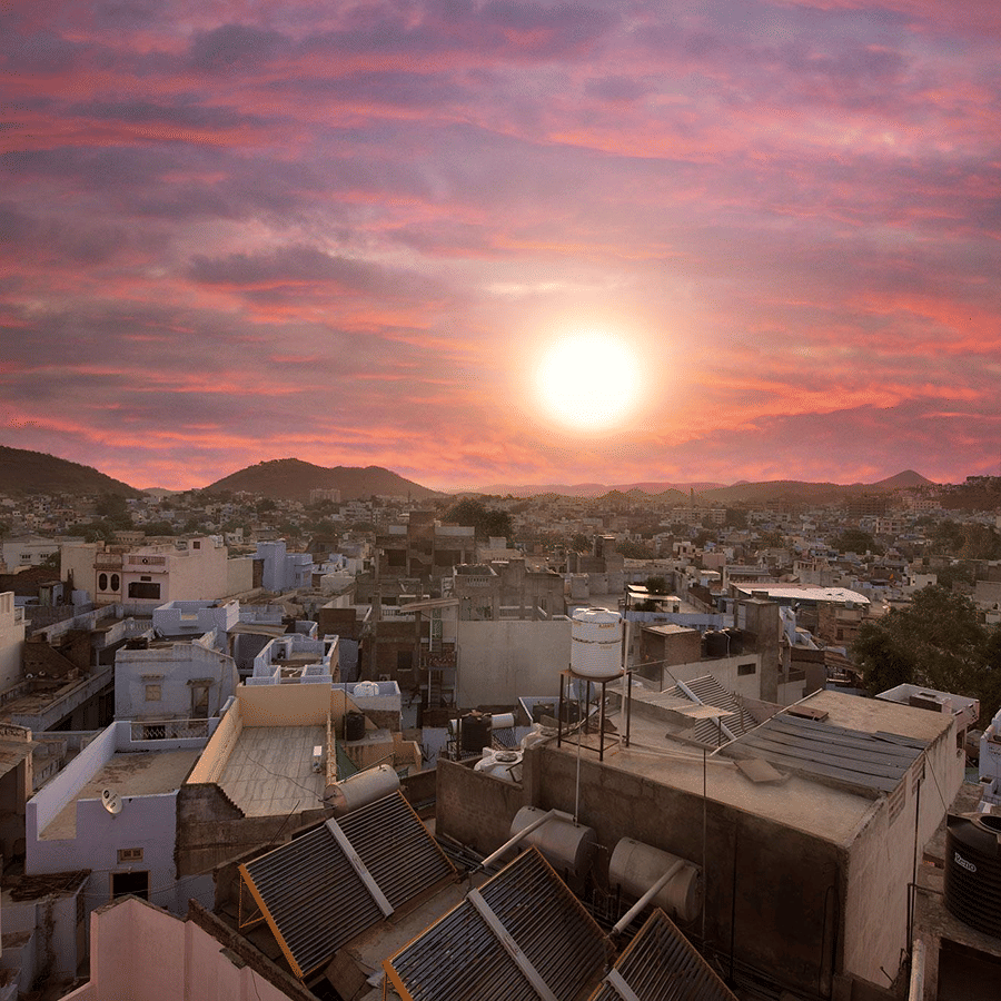 An aerial view of the Sanmukh city  with a serene pink sky during a sunset.