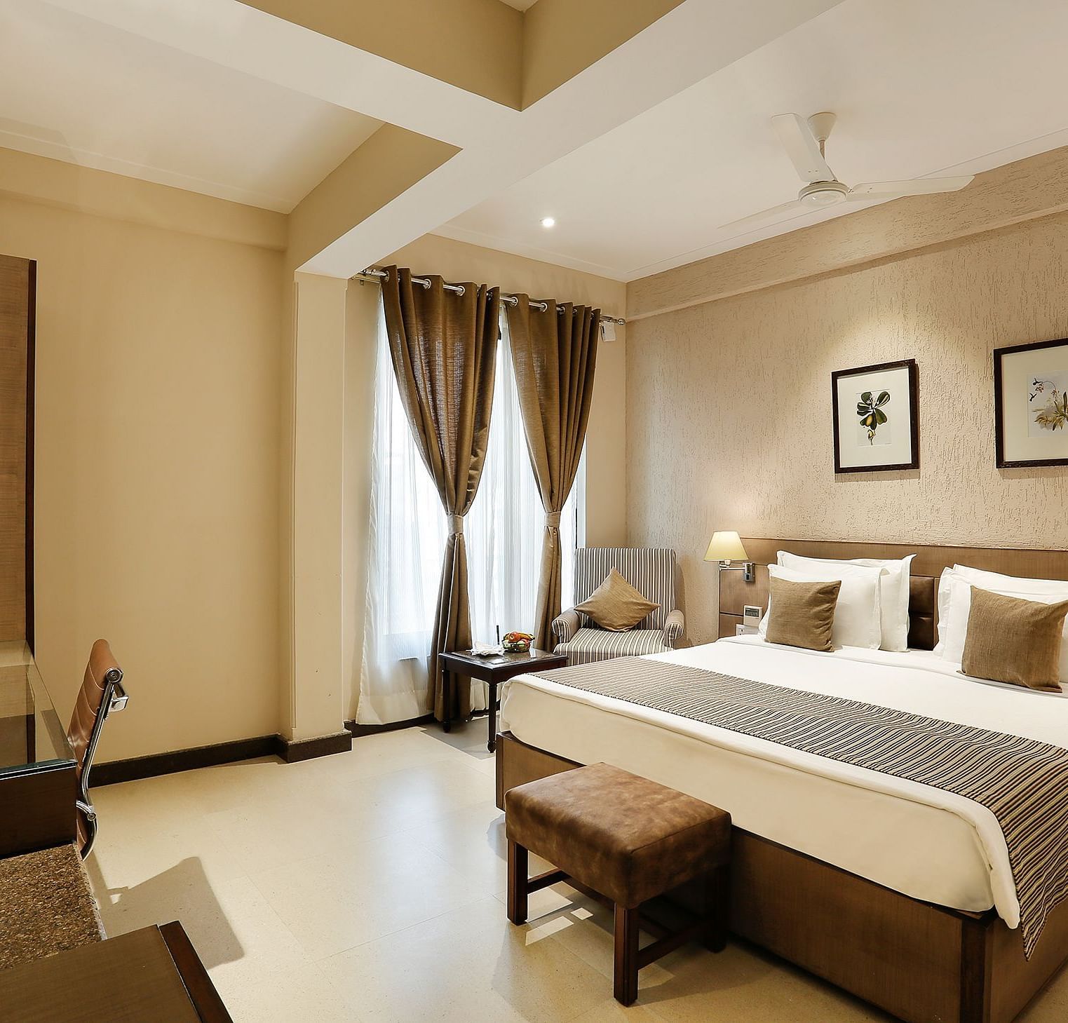 an image of suite at The Manor in Bareilly, featuring a plush bed and a stylish tea/coffee maker