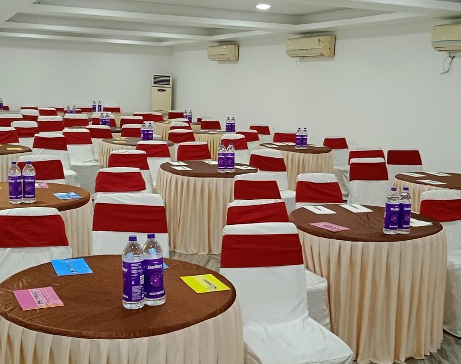 Round tables and chairs covered with cloth, and warm overhead lighting enhance and reside in the Emerald banquet hall of Mountview Resort.