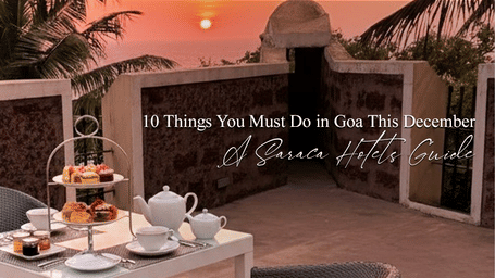 Elegant breakfast table with tea set and food, placed outdoors with warm lighting during sunset.