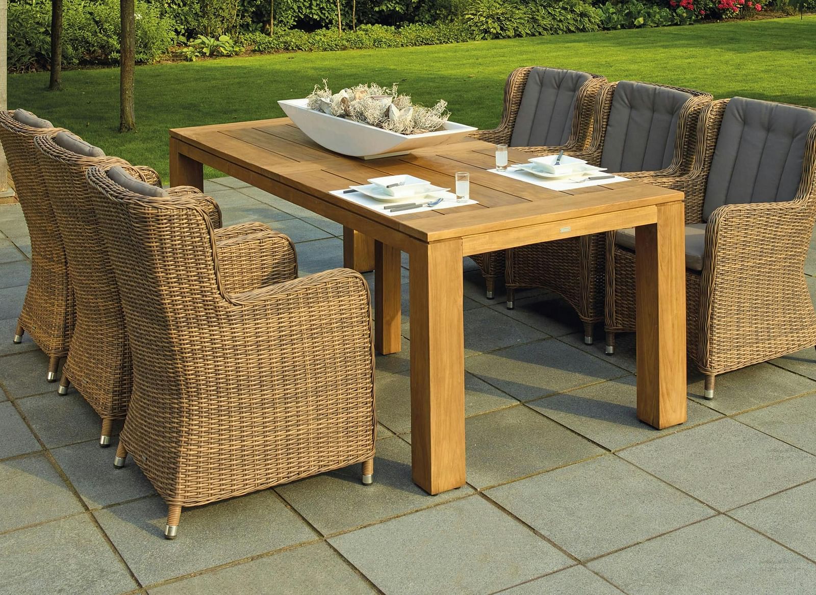 An image of a long table with chairs around it in a patio