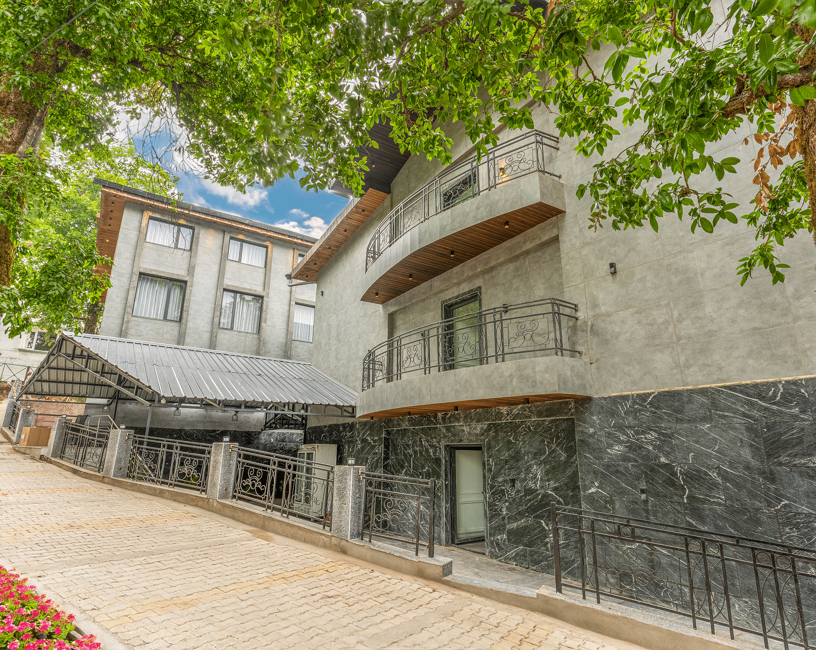 An image of facade  covered with trees at Bedzzz Xclusiv Ikshana Luxe, Nainital