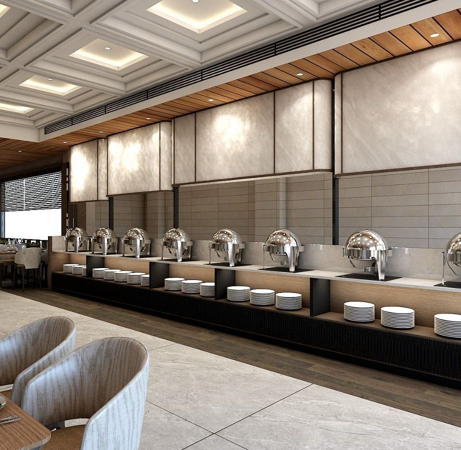 The buffet counter with various porcelain plates lined up together right behind the dining area of the restaurant - Namaste Corbett