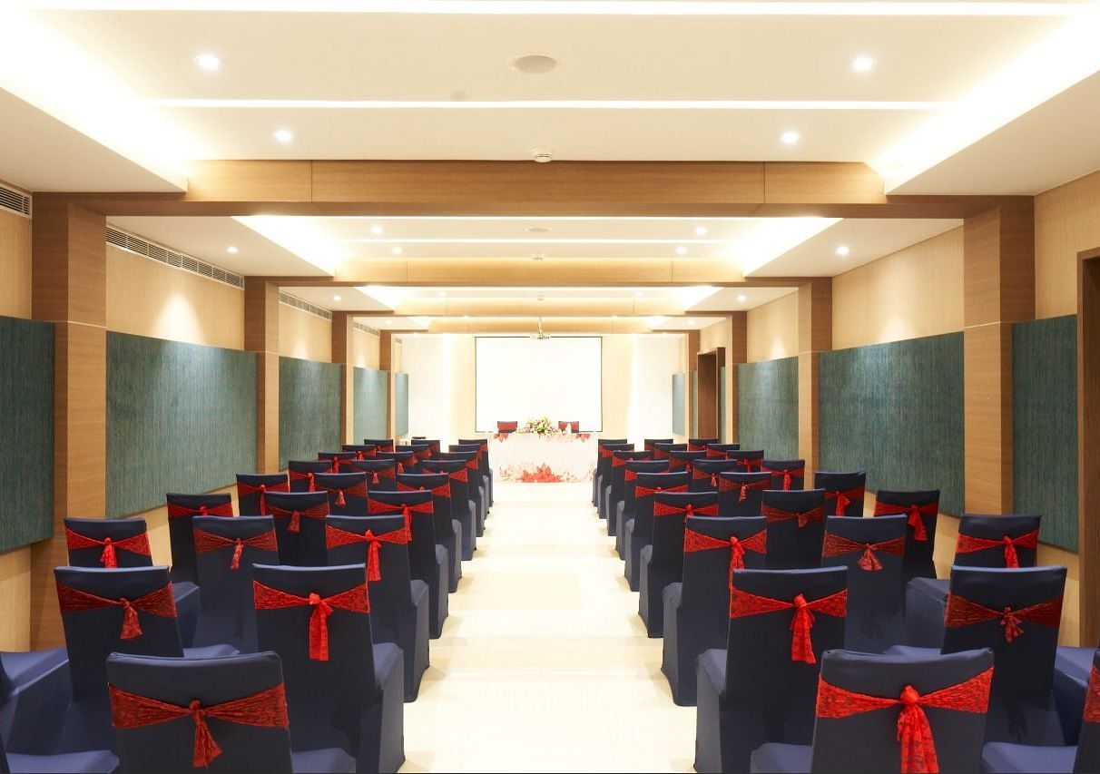 rear view of the hall with well arranged chairs at Grand Kakinada by GRT Hotels