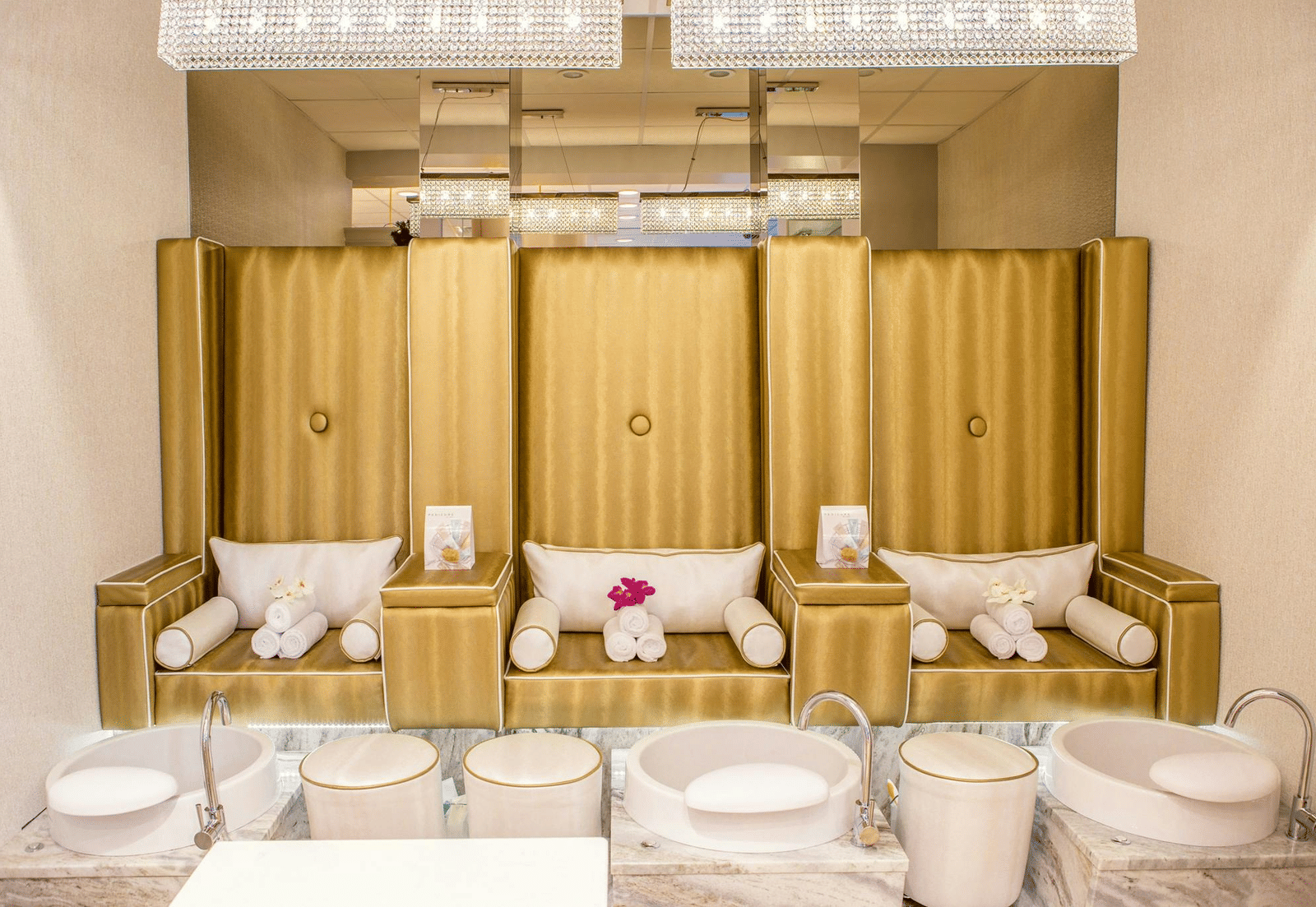 pexels-pixabaLuxurious spa pedicure area with 3 golden velvet chairs, plush cushions, individual foot basins, and a modern, elegant interior.y-161737