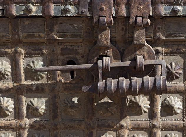 A close up shot of the traditional lock on a wooden gate - MANVAR Resort & Desert Camp