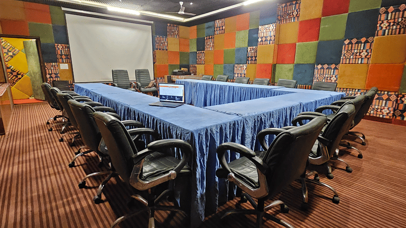 An overview of the conference room featuring a U-shaped table and chairs arranged under the table