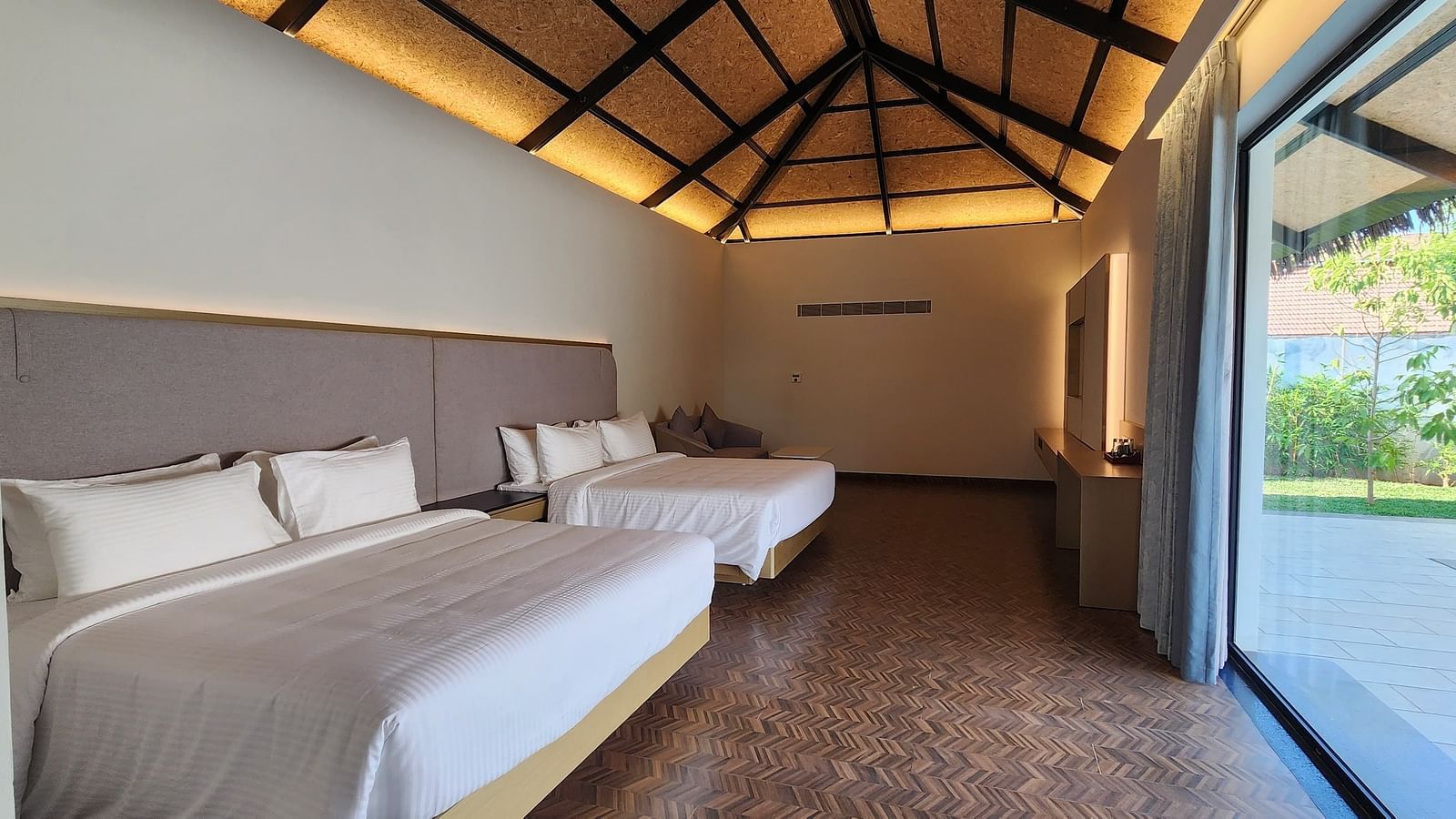 Corner view shot of the Exotic Pool Villa with the roof lined with yellow lighting at The Shore, Trishvam.
