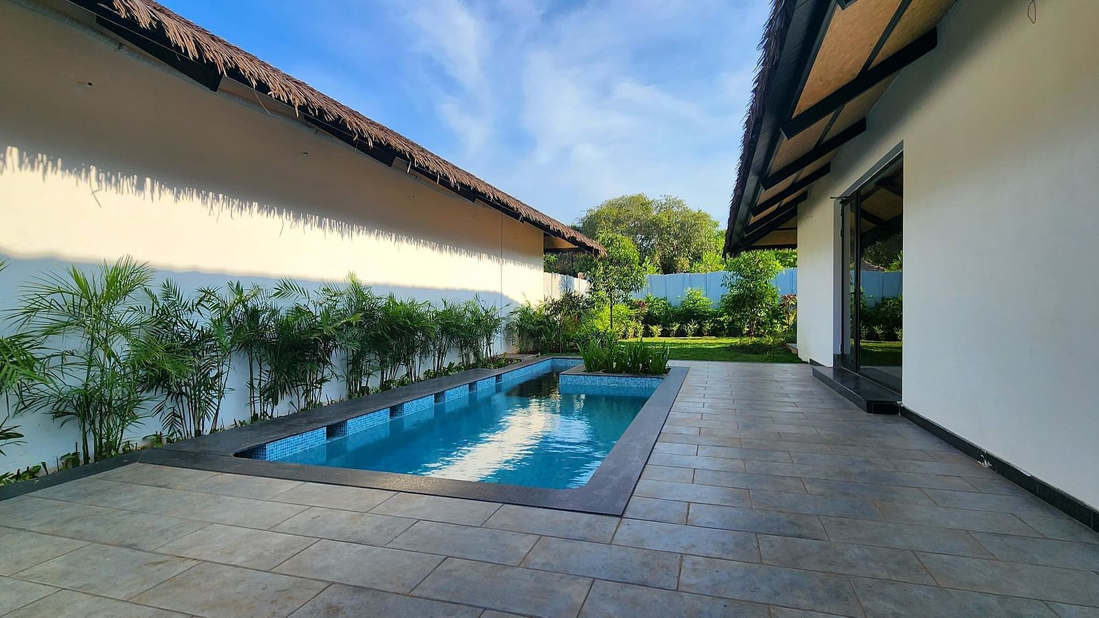 The exterior of the Exotic Pool Villa featuring a swimming pool in front of the villa at The Shore, Trishvam.