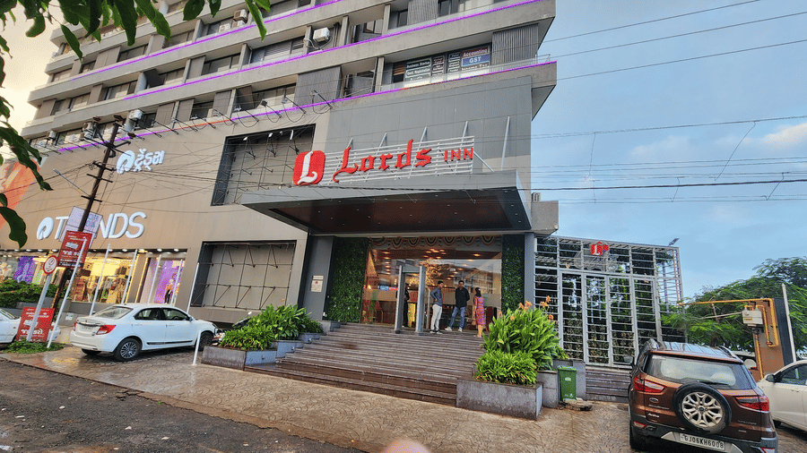 facade view of Lords Inn Rajkot with cars parked in the front and on the sides
