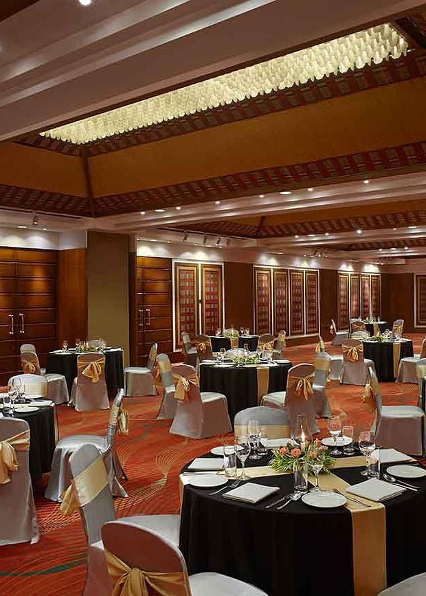 round table seating arrangements in the banquet hall at Caravela Beach Resort Goa