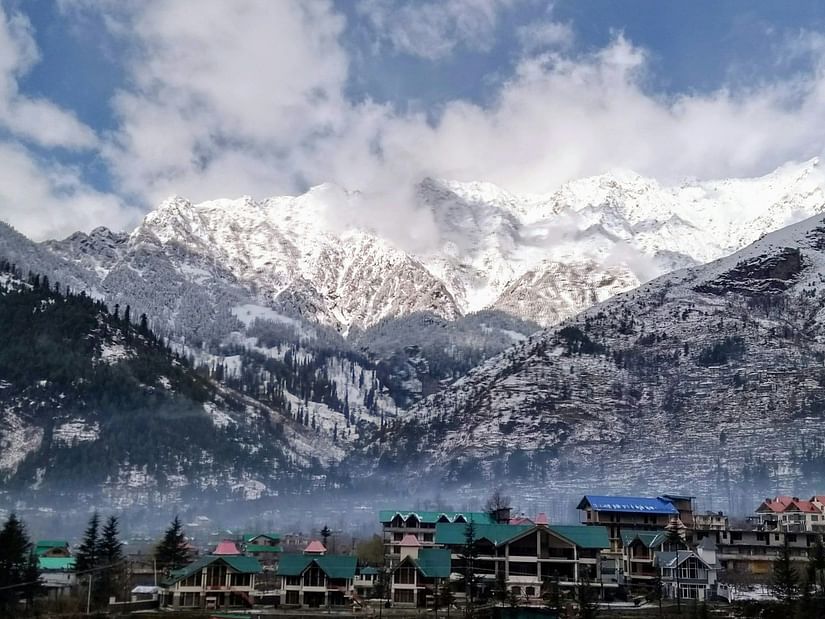 mountains with snow and a village among the trees