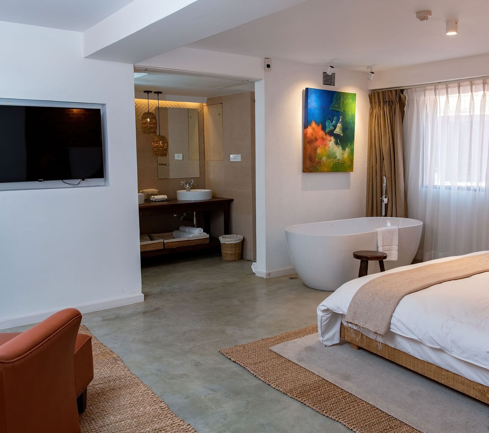 The Nepali Suite featuring a bed, flat screen TV, a sofa and a bathtub - The Nanee