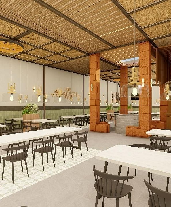 Interior view of a dining area with tables and chairs under a high ceiling | Ayana Resorts & Convention, Hyderabad