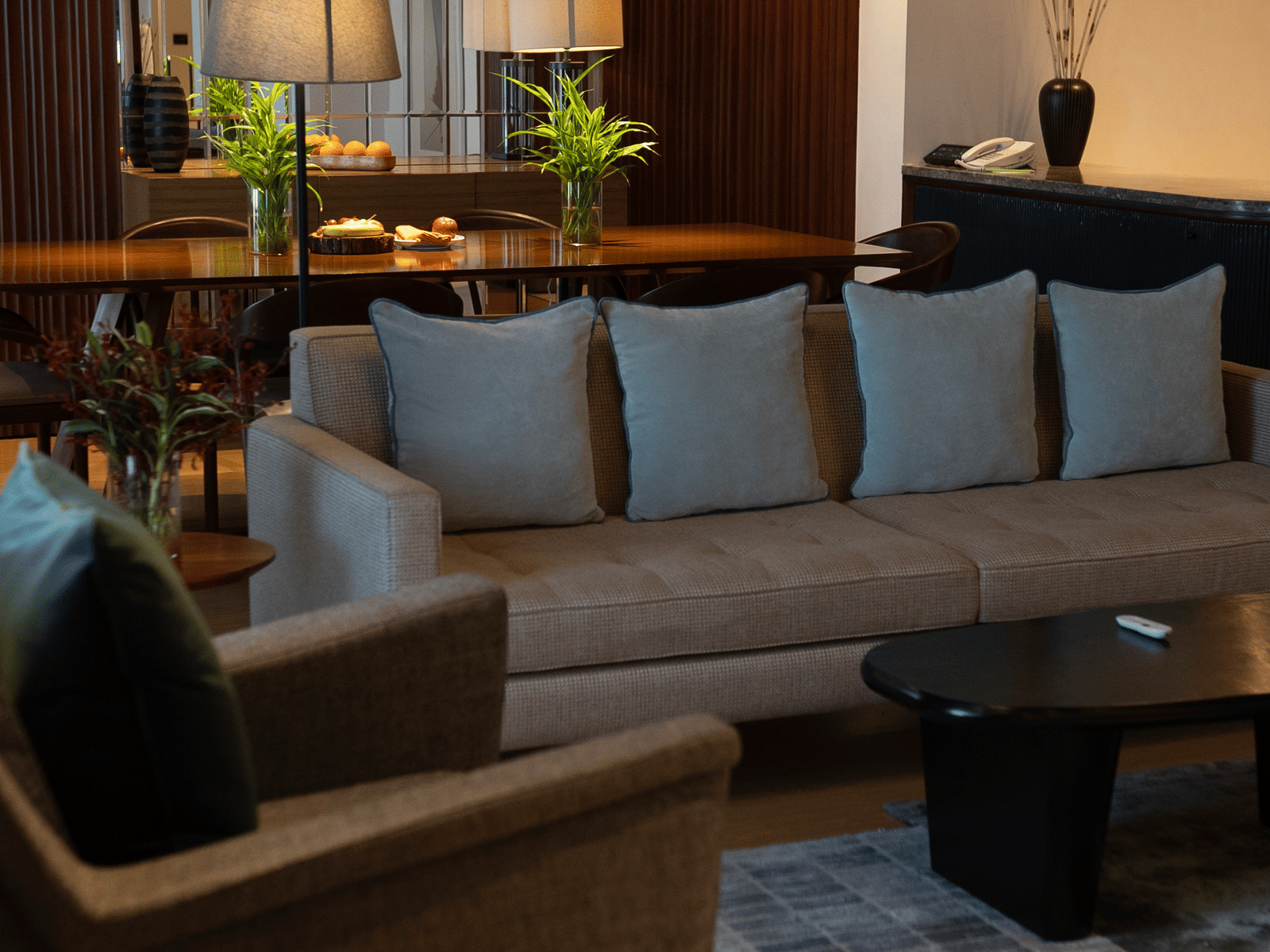 A chic hall area with a beautiful wooden table and tasteful decor, ideal for meals in your suite at The Raintree, St. Mary's Road.