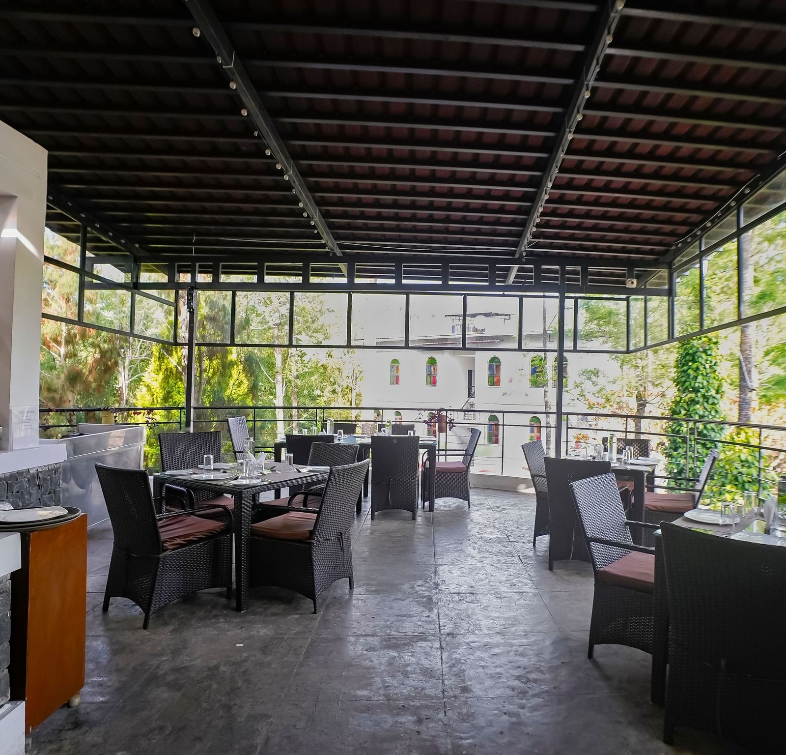 Full view of the dining area with table and chairs set at WOW Bungalow, Yercaud. 