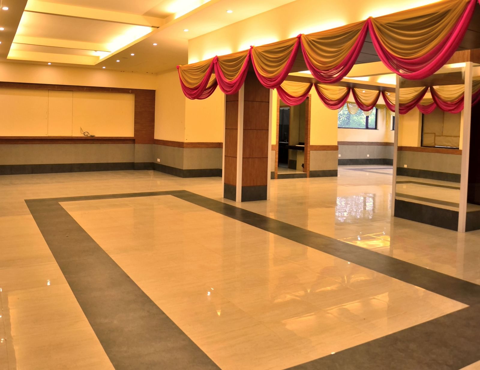 an expansive banquet hall well lit with warm lighting - Max Hotel, Jabalpur