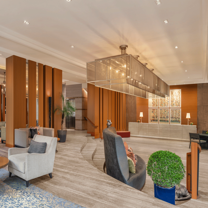 Living area with sofas, chairs, and wooden interiors at The Raintree, St. Mary’s Road.