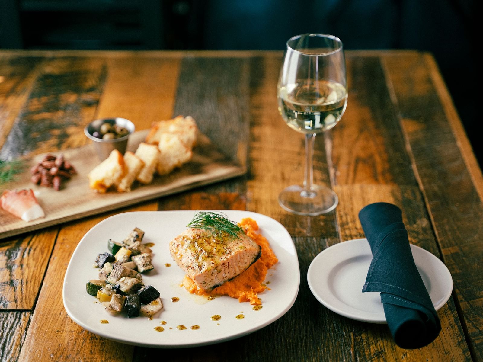 A view of a dish served alongside a glass of champagne
