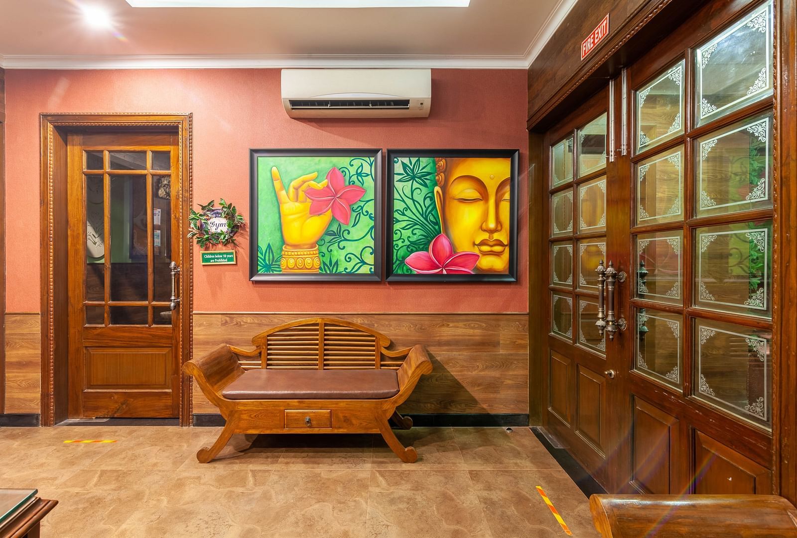 a wall filled with two paintings and a sofa in front of the wall - Mayfair Palm Beach Resort, Gopalpur-on-Sea