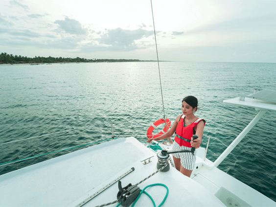 a girl sailing a yacht in a sea