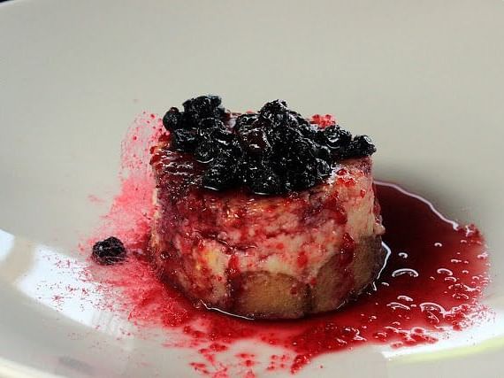 An image of a dessert served on a plate garnished with blueberries