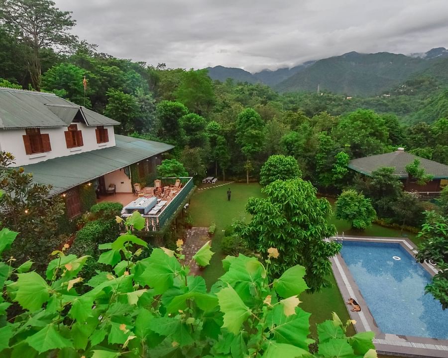 Lush green landscape with a resort nestled amongst the hills.