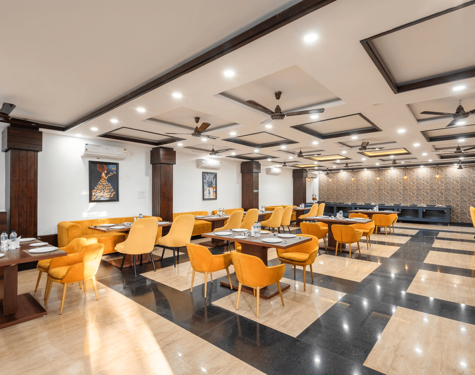 A dining hall with many tables and chairs and patterned floor tiles at Perfectstayz Premium Shanti Heritage, Haridwar