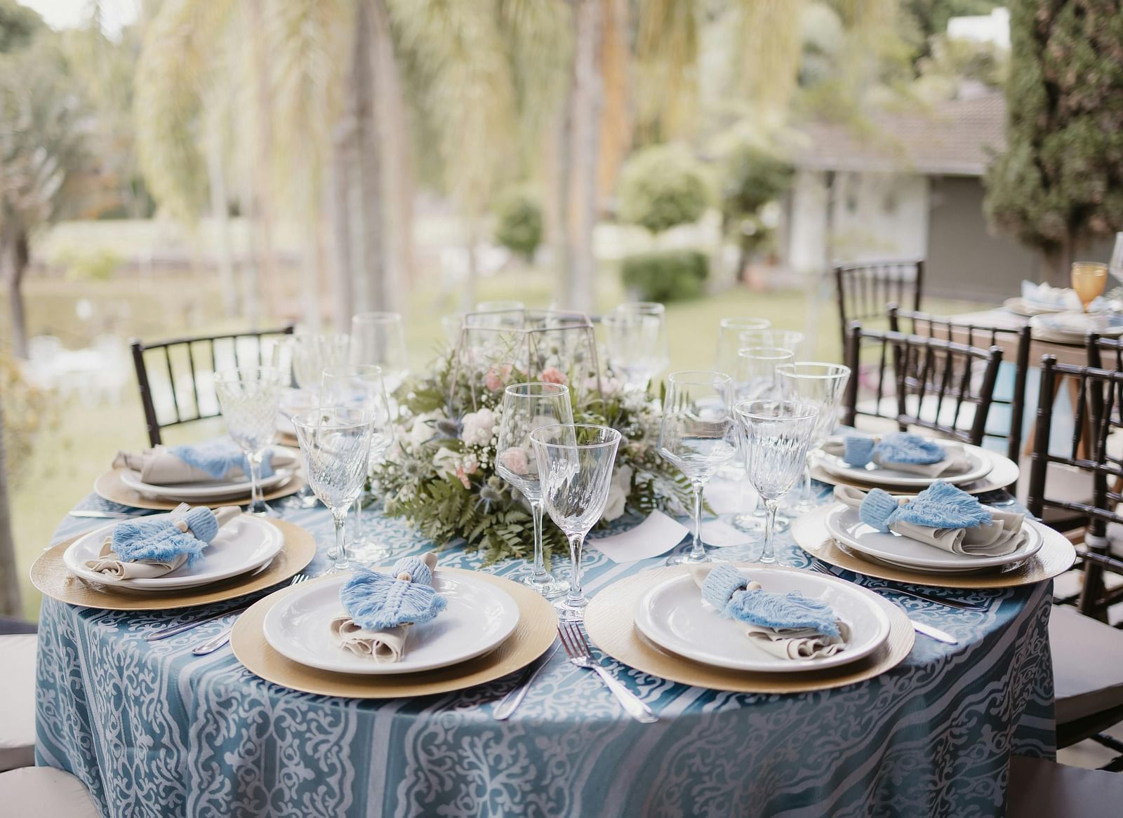 A beautifully arranged table and chairs, adorned for an event.