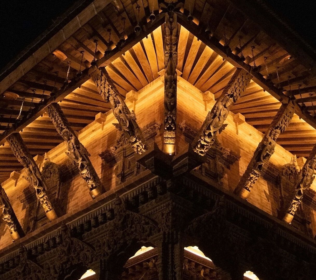 The carvings on a temple structure which is brightly lit