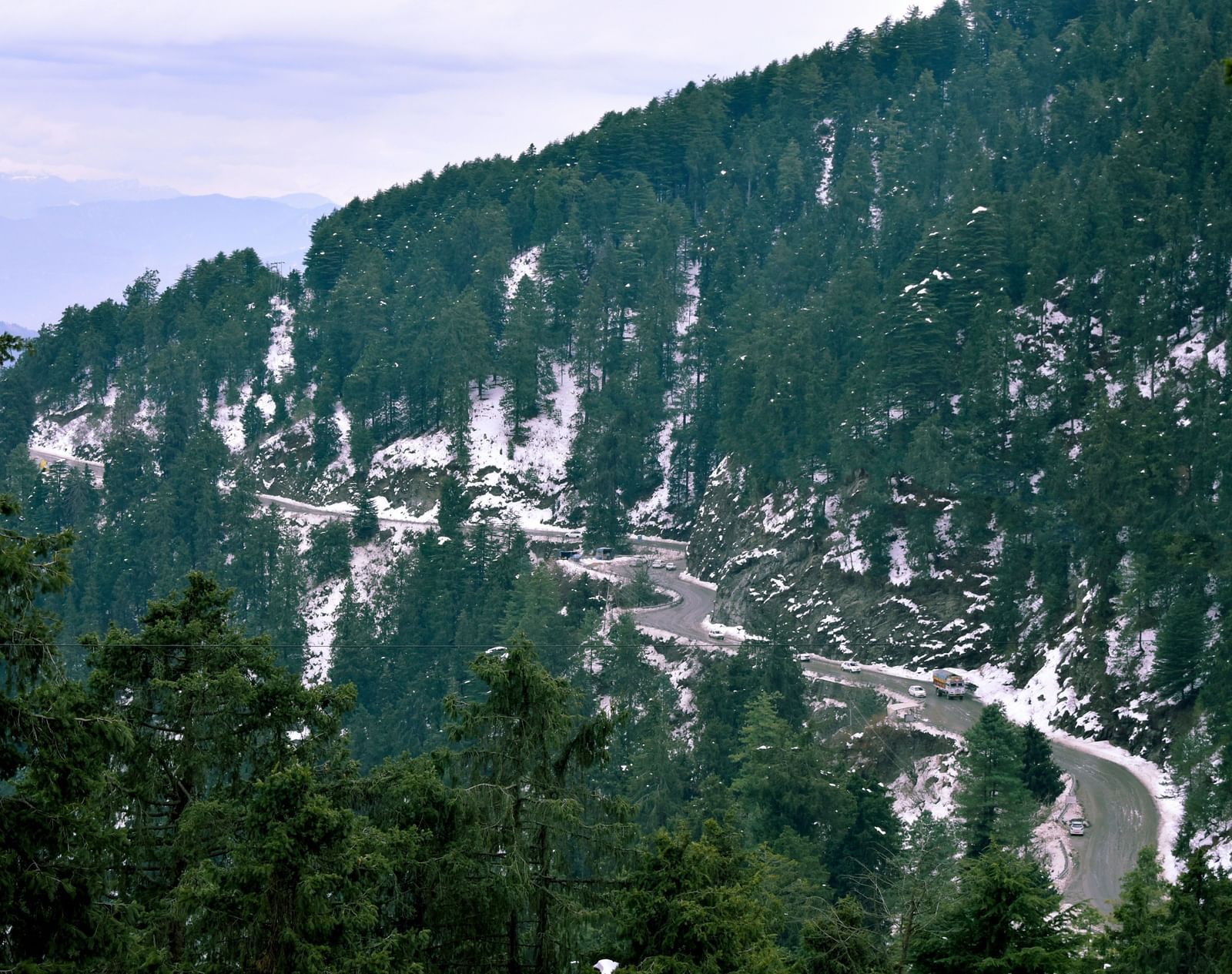 Scenic mountain view with winding bend roads.