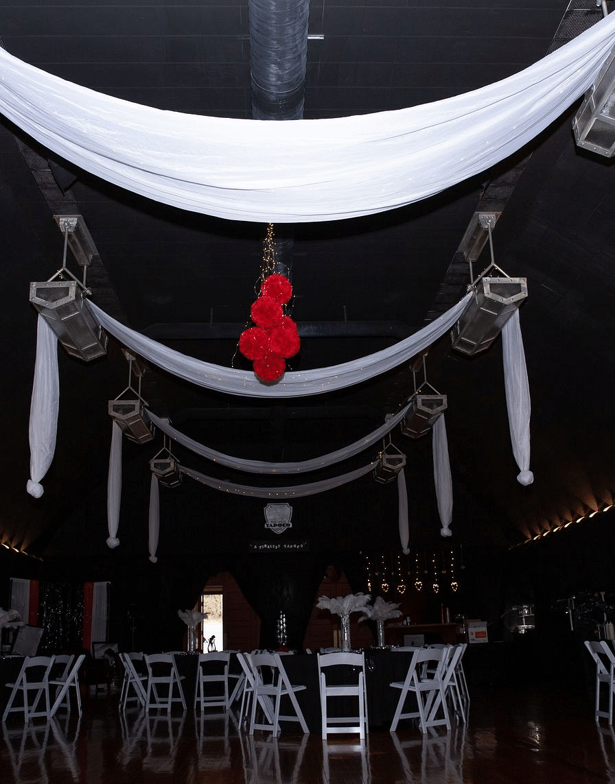 The Tin Can Theater with beautiful decoration for a party featuring white linen hanging from the ceiling - Historic Tapoco Lodge