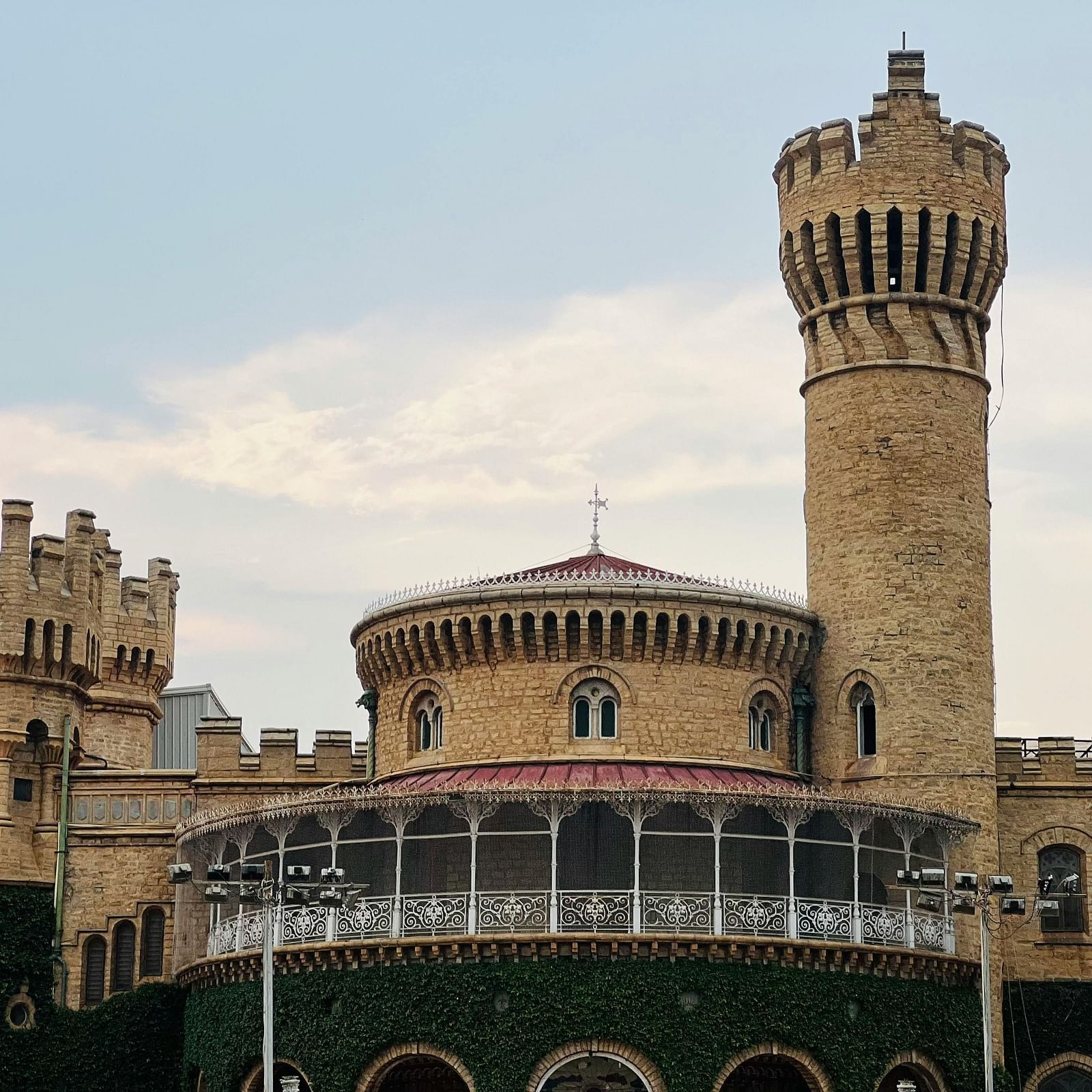 Exterior view of Bangalore Palace showcasing its stone facade and grounds.