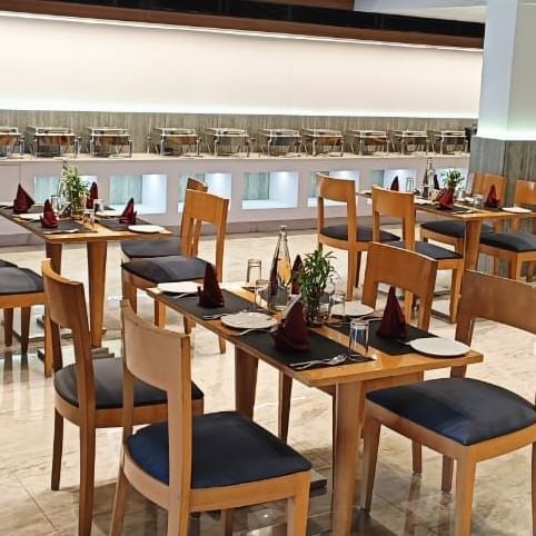 All-day dining restaurant at Lords Eco Inn Dahej offering a welcoming ambience with wooden décor.