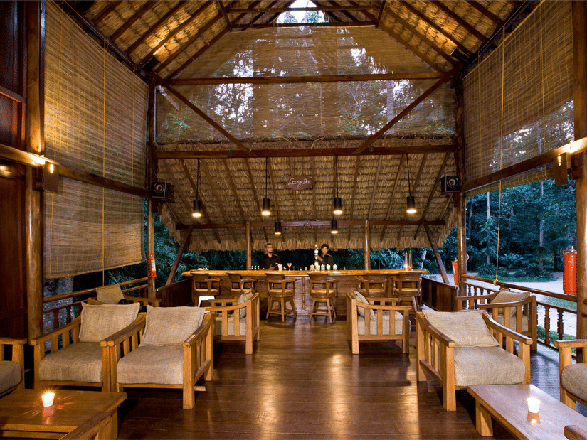 Tables arranged at Dugong Dugon Bar, our restaurant in Havelock, featuring 2 bartenders facing the 2 rows of chairs and tables
