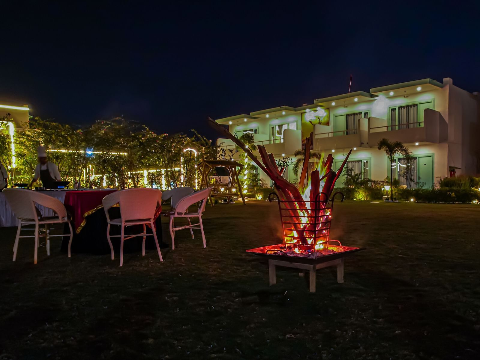 Bonfire setup with chairs around on the lawn, creating a cosy evening atmosphere at Vedikant Resorts The Mallard Corbett.