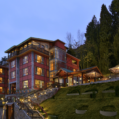Facade at Golden Tulip,Srinagar featuring breathtaking view of the property in the evening amidst lush greenery
