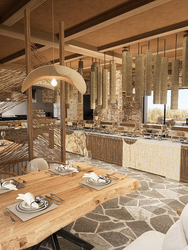Diagonal view of the restaurant with neatly set tables and chairs, featuring a central table with a buffet setup at The Evren, Vagator.