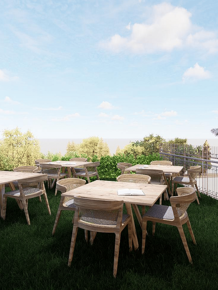 Open-air dining area surrounded by trees and plants with the sky overhead at The Evren, Vagator.