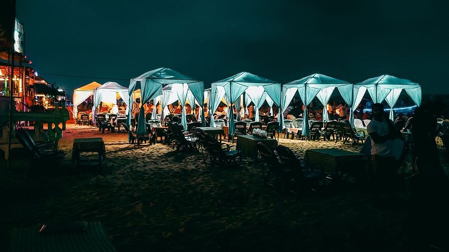 A night market with well-lit stalls in North Goa