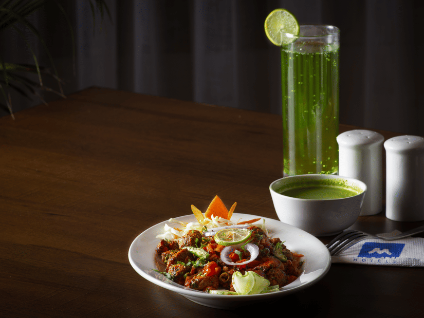A beautifully plated gourmet dish served with a refreshing green beverage and a dip | Mount Lungta Boutique Hotel & Spa