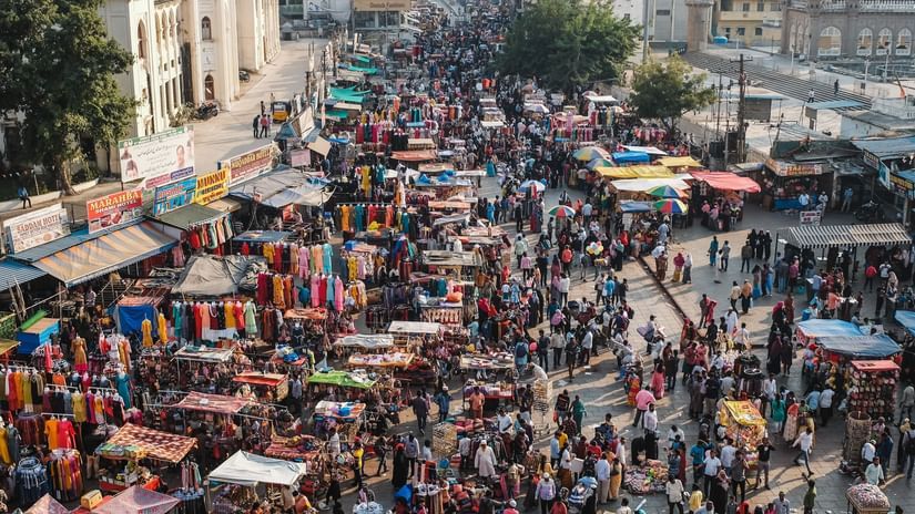 A sub-aerial view of a crowded market during the day, near Chidambara Vilas.