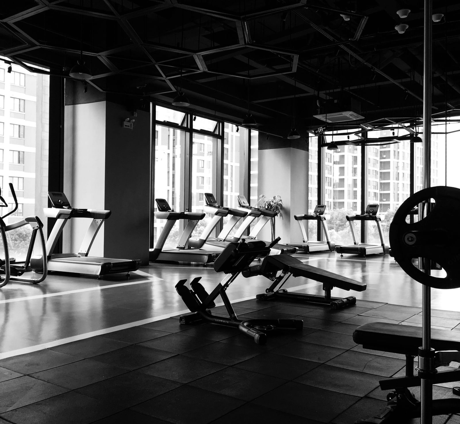 A wide angle shot of a fitness centre with various exercise and weightlifting equipment.